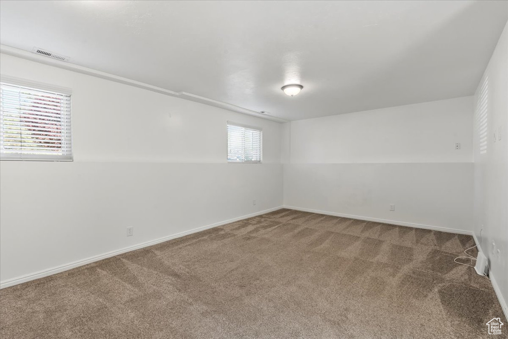 Spare room with carpet floors, baseboards, and visible vents