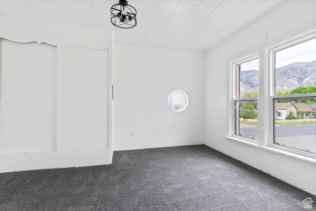 Spare room featuring carpet floors and a mountain view