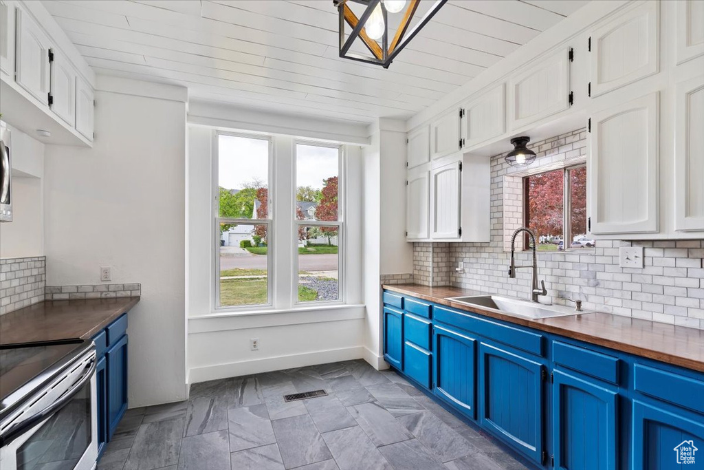 Kitchen with a healthy amount of sunlight and blue cabinetry