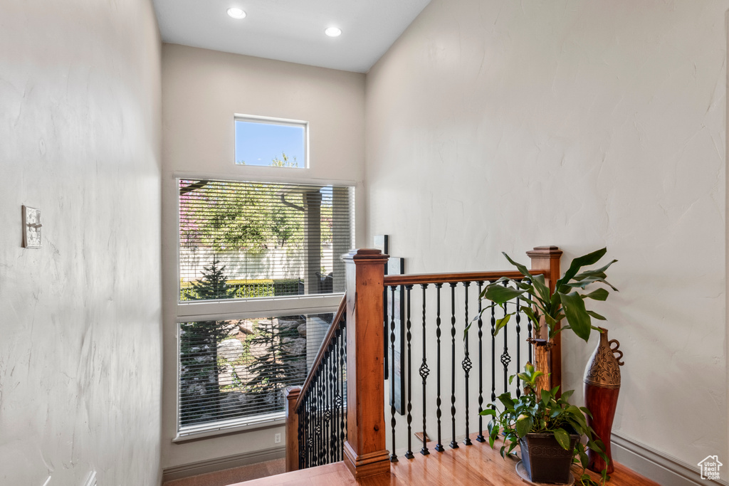 Interior space featuring a high ceiling, recessed lighting, and wood finished floors