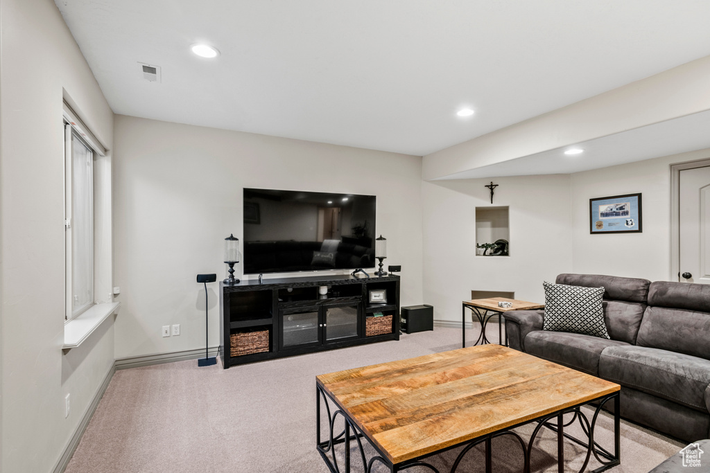 Carpeted living room with baseboards, recessed lighting, and visible vents
