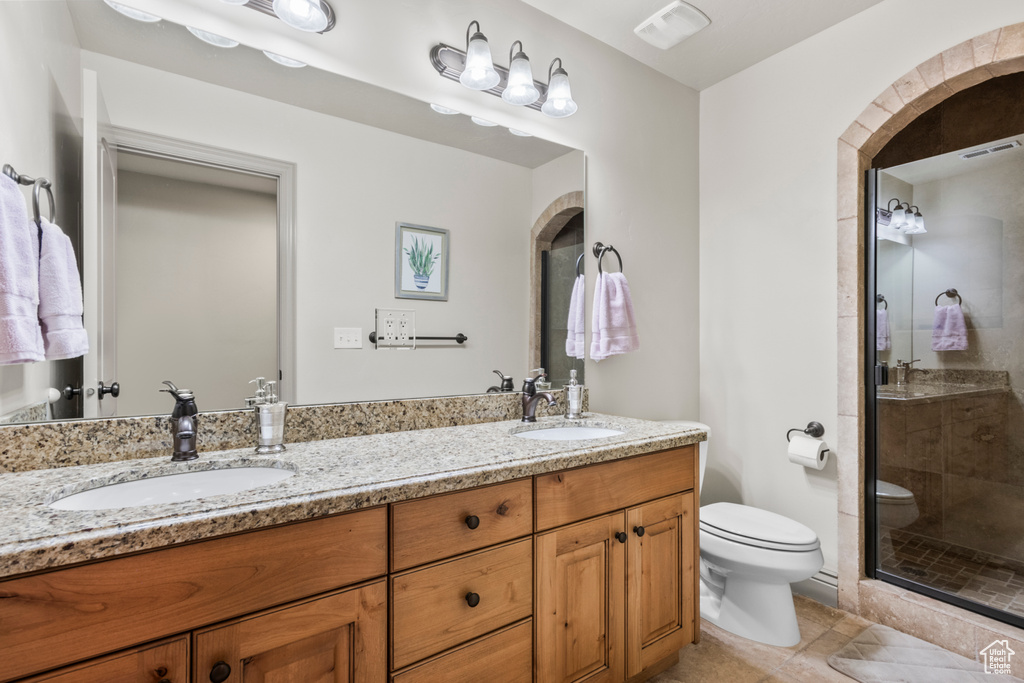 Bathroom with tile patterned flooring, a sink, visible vents, and toilet