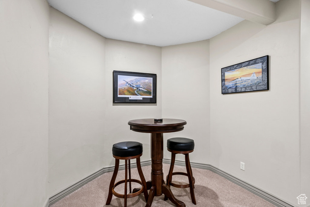 Dining area featuring baseboards and carpet flooring