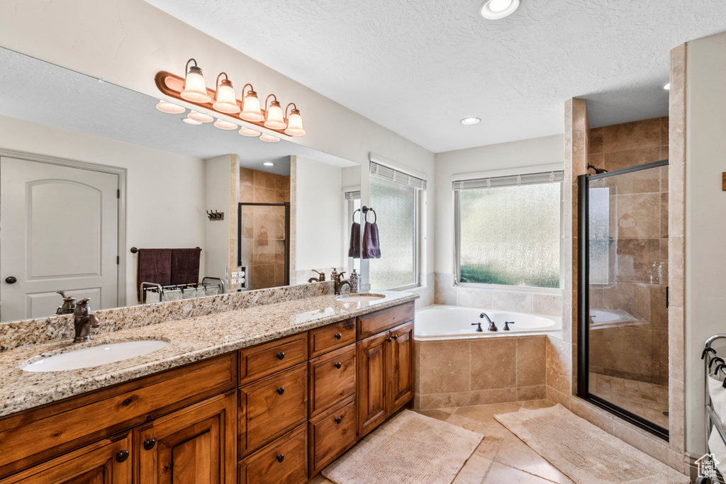 Bathroom with a sink, double vanity, a shower stall, and a bath