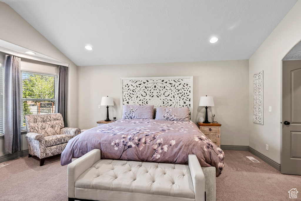Bedroom featuring baseboards, vaulted ceiling, recessed lighting, and light colored carpet