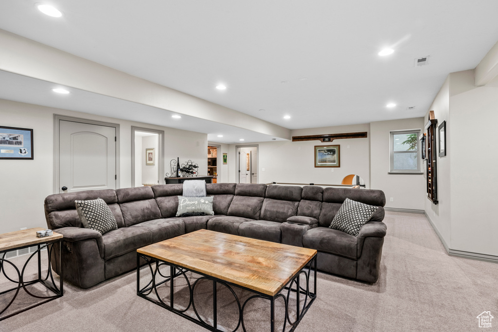 Living area with recessed lighting, bar, and light carpet