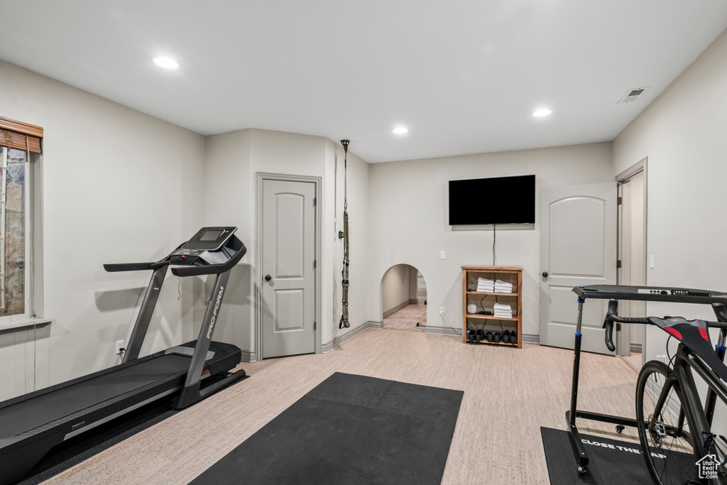 Workout room featuring recessed lighting, baseboards, wood finished floors, and visible vents