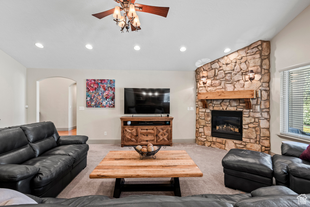 Living area with ceiling fan, arched walkways, vaulted ceiling, carpet floors, and recessed lighting