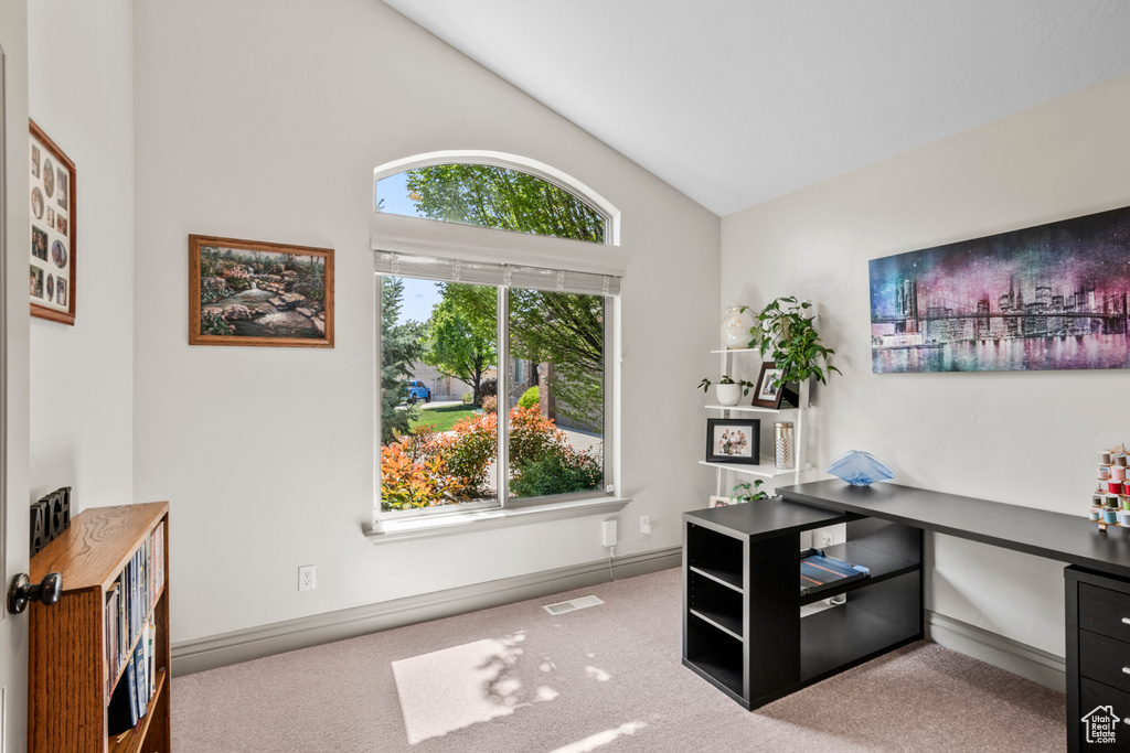 Office space with visible vents, carpet flooring, baseboards, and high vaulted ceiling