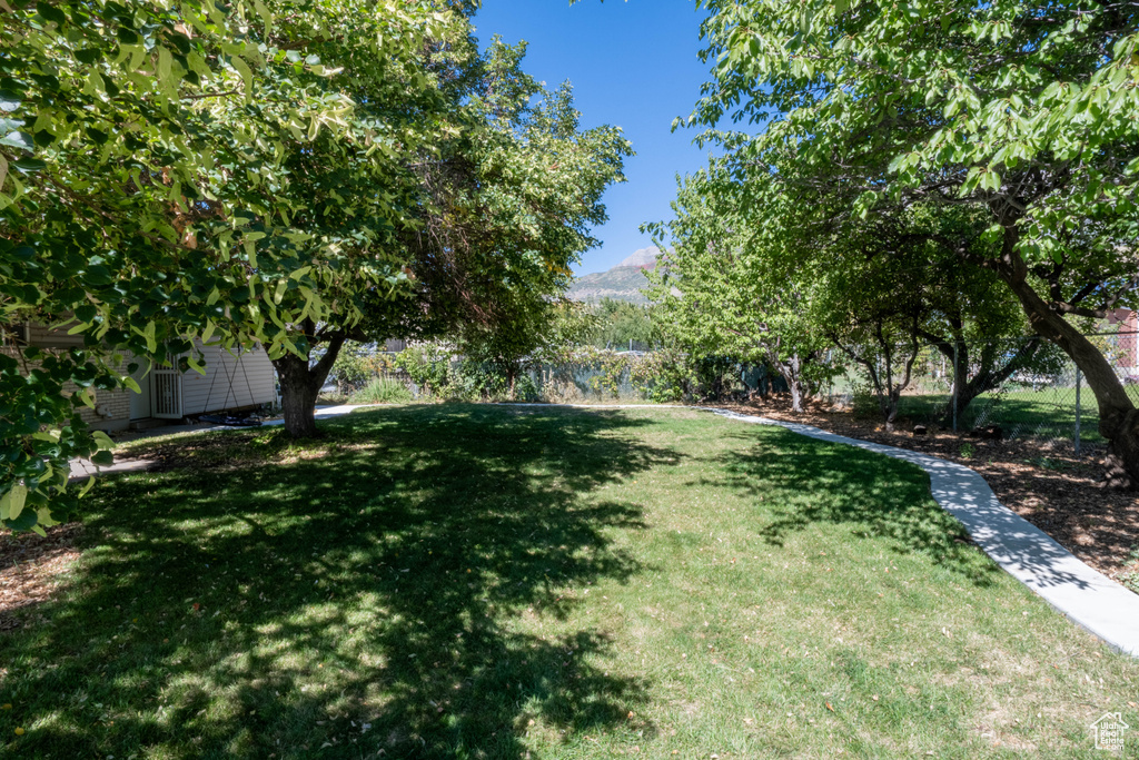 View of yard featuring fence and a mountain view