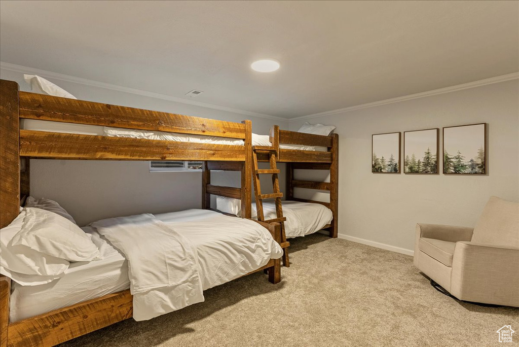 Bedroom with baseboards, ornamental molding, and carpet flooring