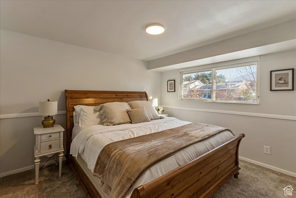 Bedroom with baseboards and carpet