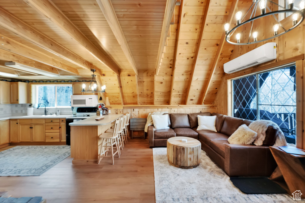 Living room with wooden ceiling, an AC wall unit, and a chandelier
