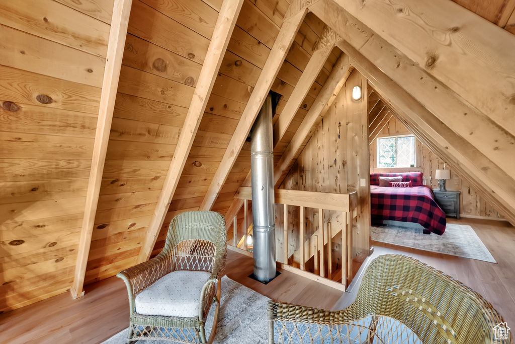 Bedroom with wood finished floors and lofted ceiling