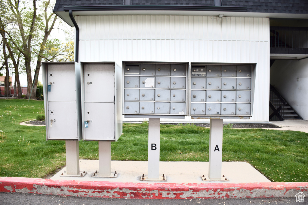 View of home\'s community with a yard and mail area