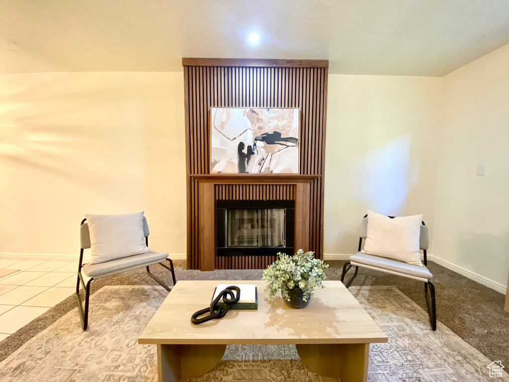 Sitting room with baseboards and a fireplace
