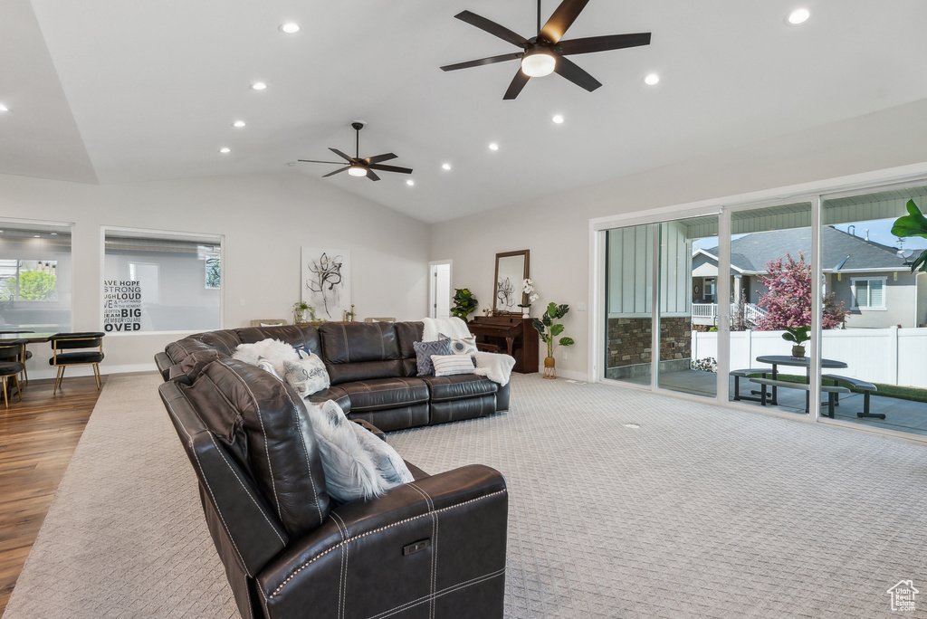 Living room featuring baseboards, ceiling fan, recessed lighting, wood finished floors, and vaulted ceiling