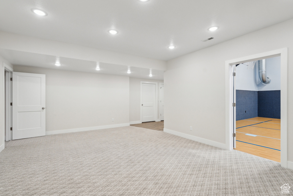 Basement featuring visible vents, baseboards, recessed lighting, and carpet flooring