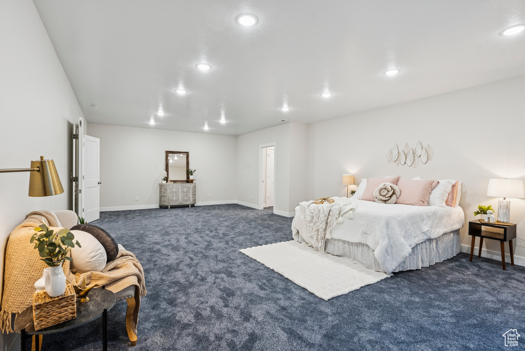 Bedroom featuring dark colored carpet, recessed lighting, and baseboards