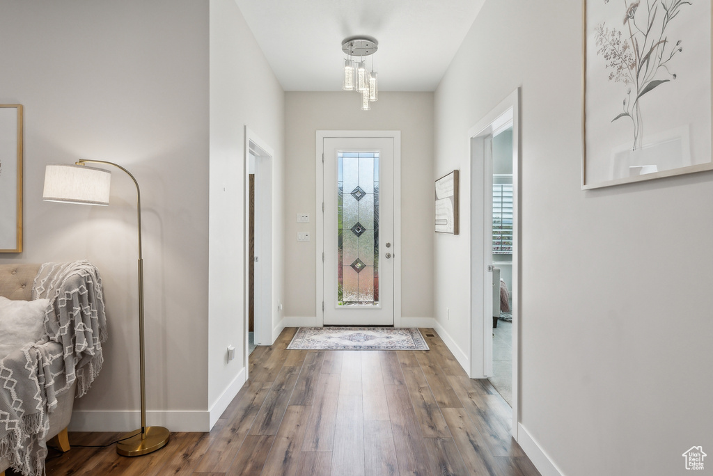 Entrance foyer featuring baseboards and wood finished floors