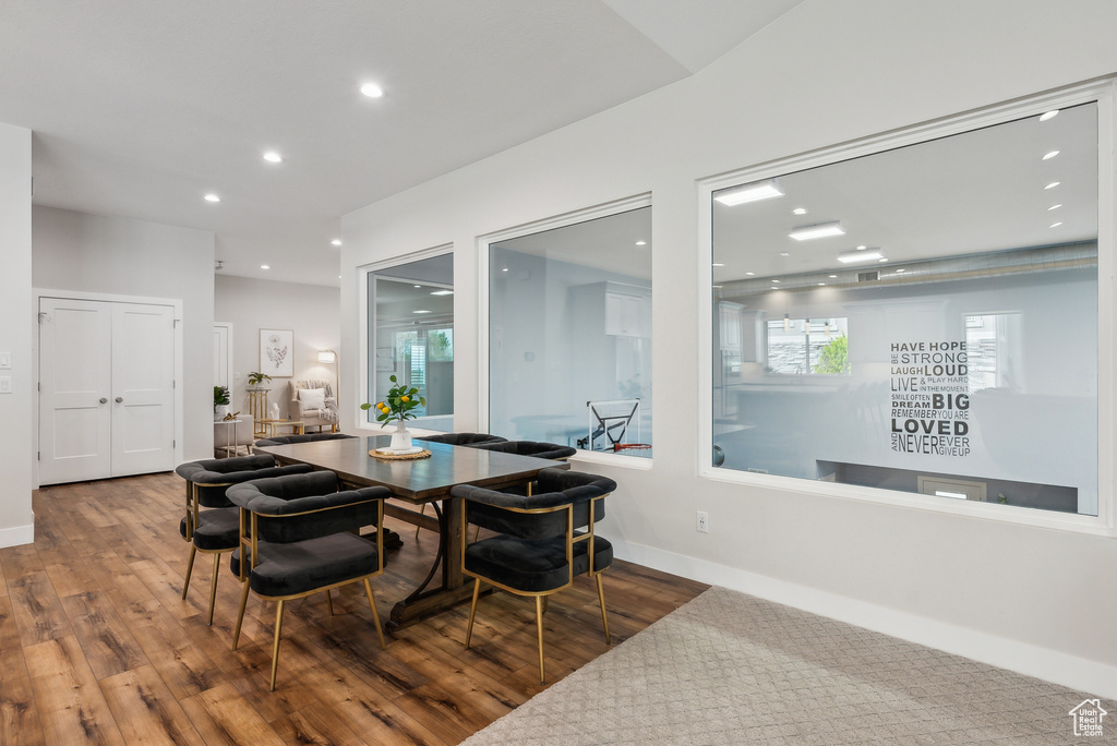 Dining space with wood finished floors, baseboards, and recessed lighting