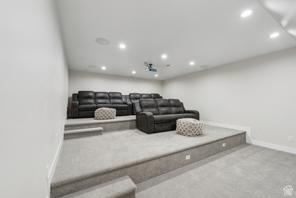 Carpeted living room with baseboards and recessed lighting