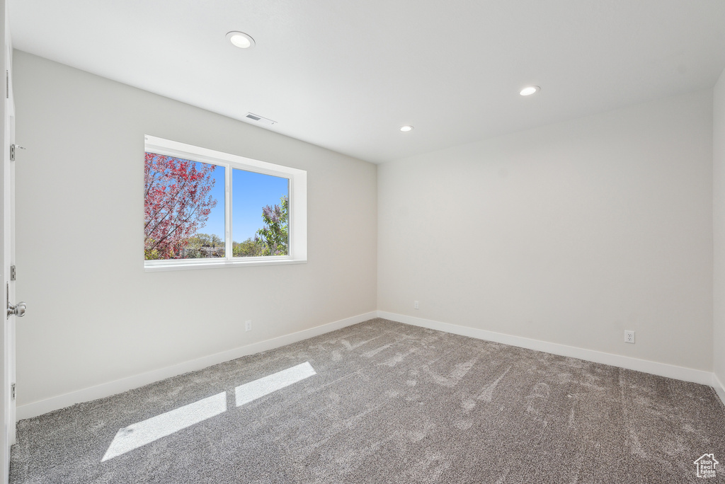 Spare room featuring recessed lighting, baseboards, visible vents, and carpet floors
