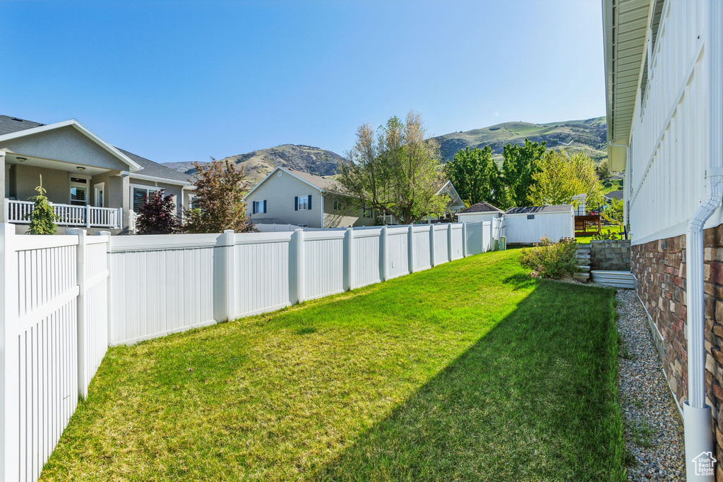 View of yard with a fenced backyard and a mountain view