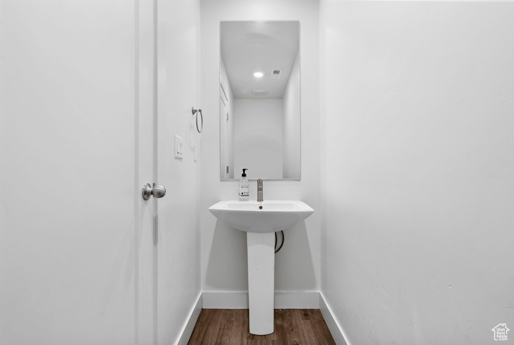 Bathroom featuring baseboards and wood finished floors