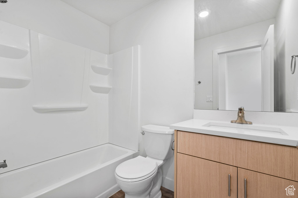 Full bath featuring toilet, washtub / shower combination, and vanity