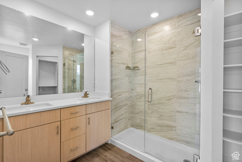 Full bath featuring a sink, a stall shower, and visible vents
