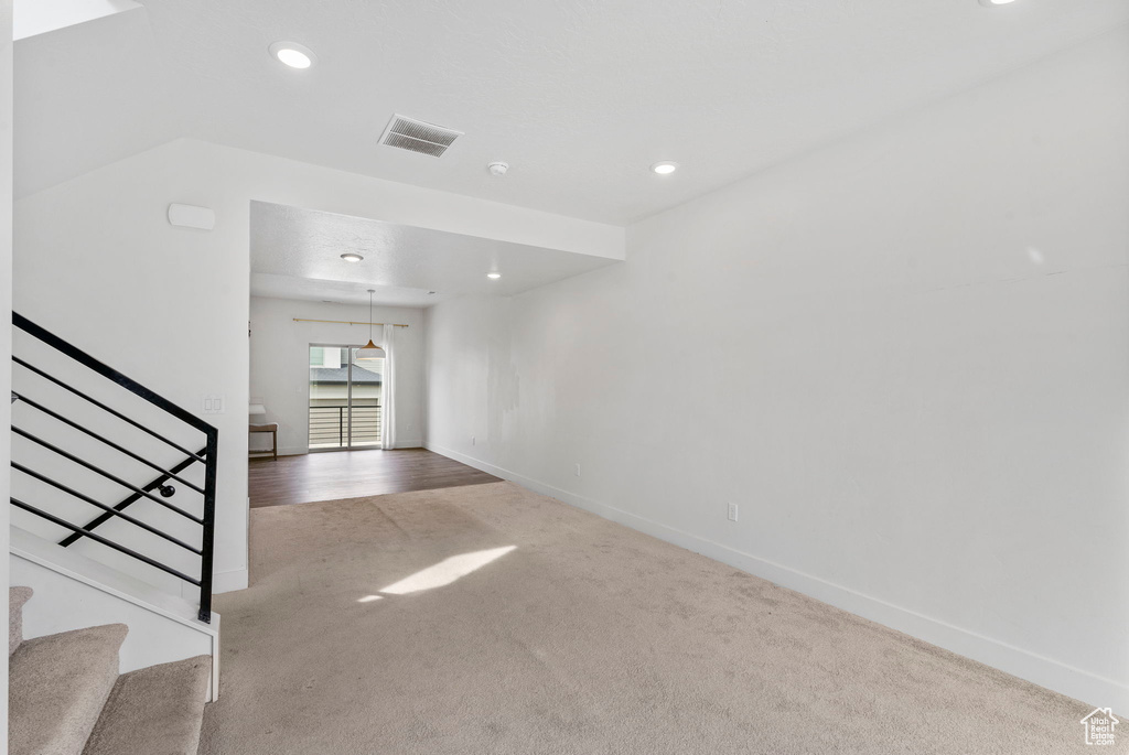 Interior space featuring stairway, baseboards, recessed lighting, and carpet