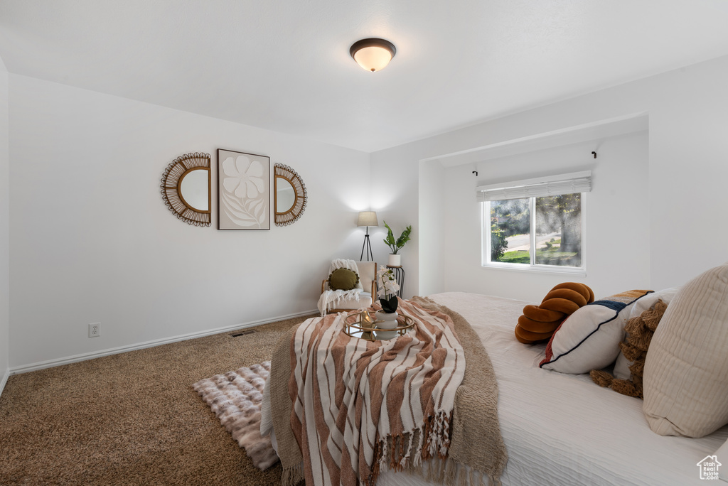 Carpeted bedroom featuring baseboards
