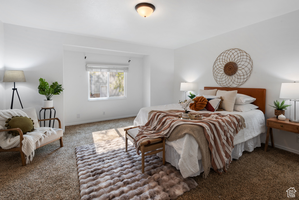 Bedroom featuring carpet floors and baseboards