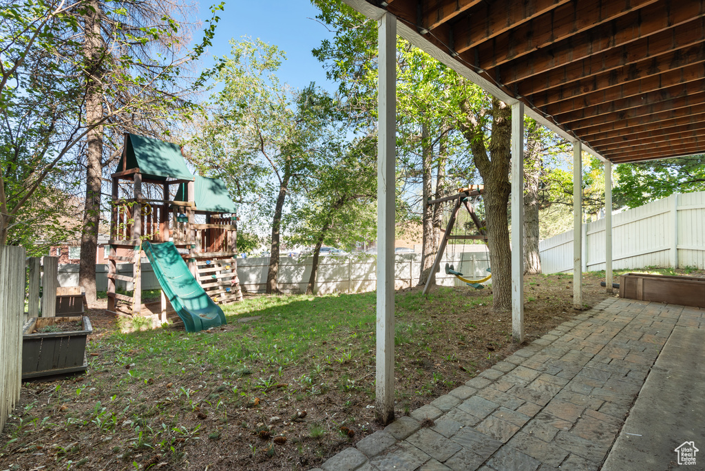 Exterior space featuring a fenced backyard and a playground