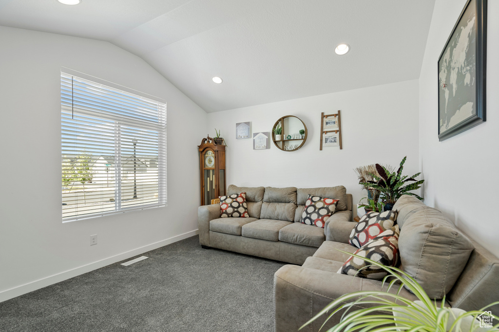 Living room with carpet flooring, recessed lighting, vaulted ceiling, and visible vents