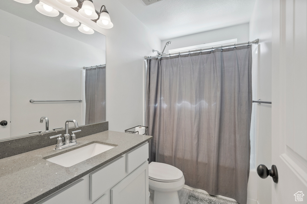 Full bathroom with vanity and toilet