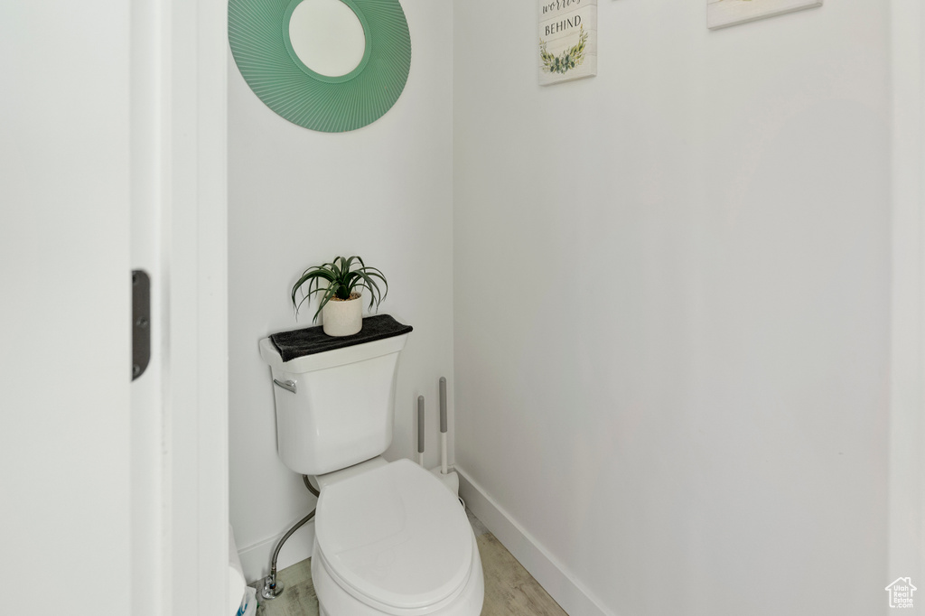 Bathroom featuring baseboards and toilet