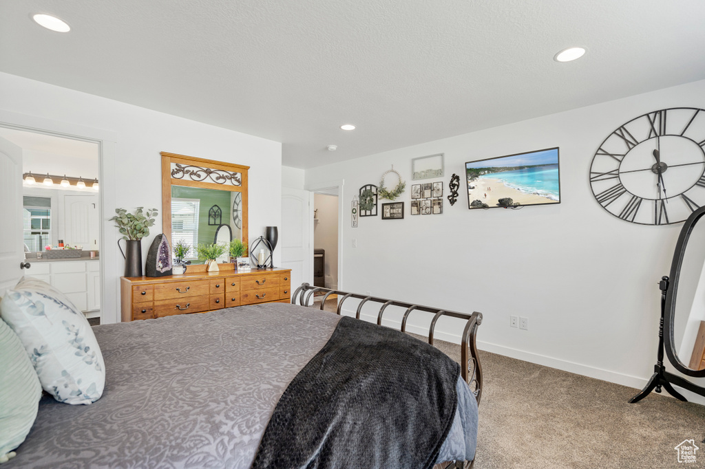 Carpeted bedroom featuring recessed lighting, connected bathroom, and baseboards