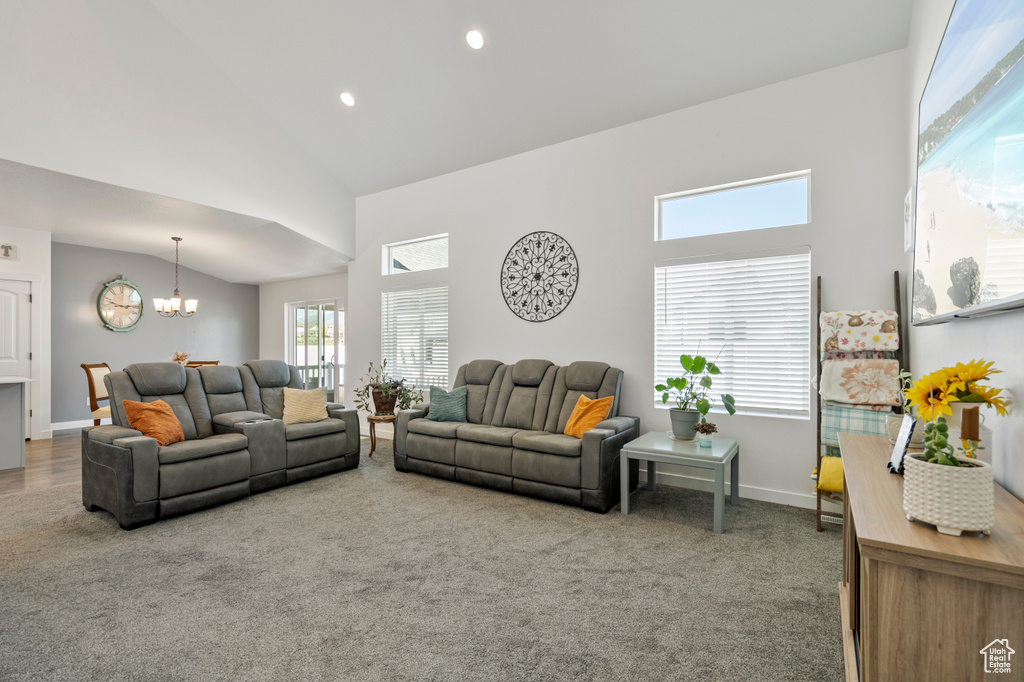 Living area featuring baseboards, high vaulted ceiling, recessed lighting, carpet, and a notable chandelier