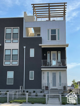 View of front of property with a balcony