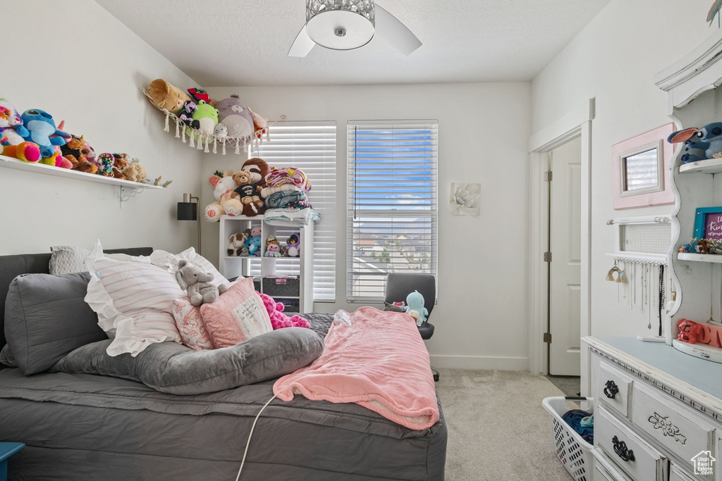Bedroom featuring carpet flooring, baseboards, and ceiling fan