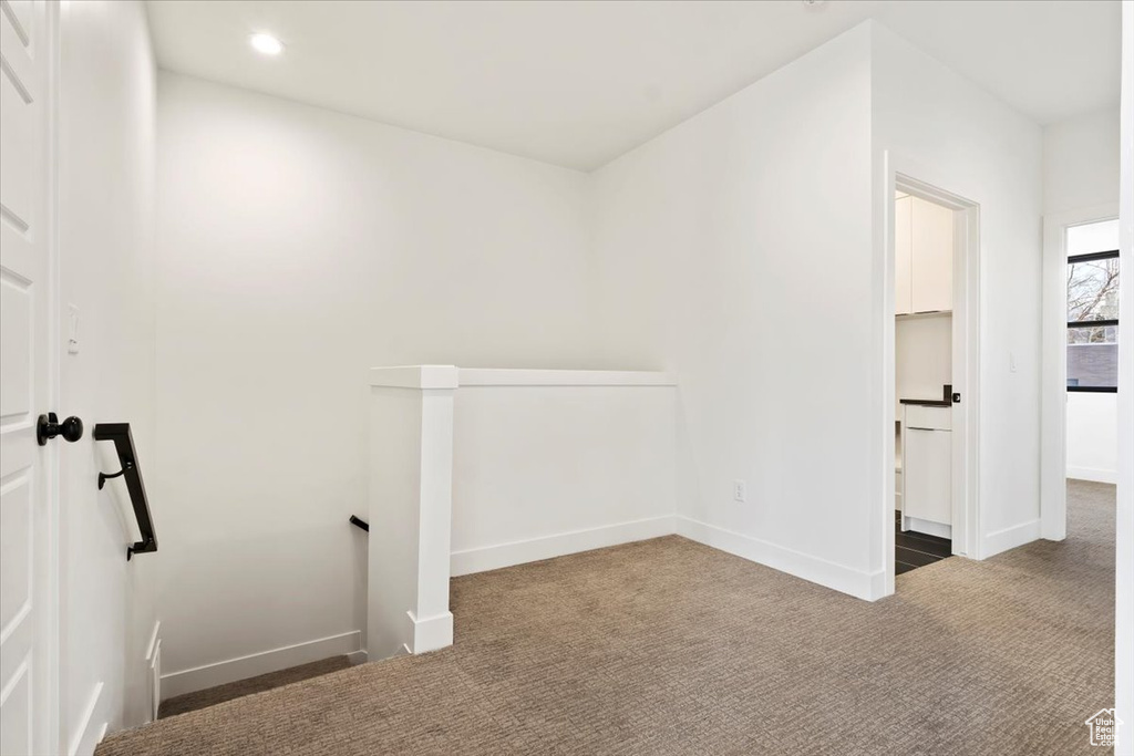 Carpeted spare room featuring baseboards and recessed lighting