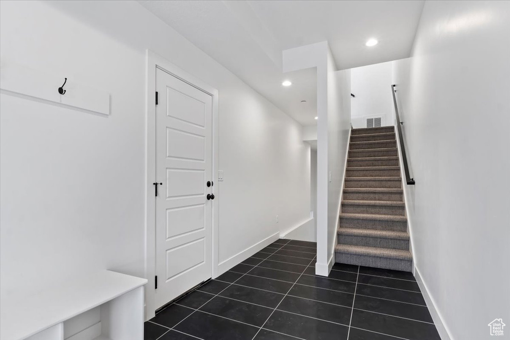 Stairs featuring recessed lighting, tile patterned floors, and visible vents