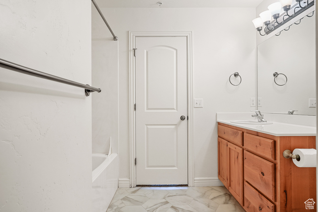 Bathroom with marble finish floor and vanity