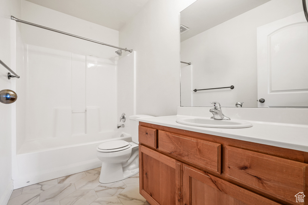 Bathroom with vanity, shower / bathtub combination, toilet, marble finish floor, and visible vents