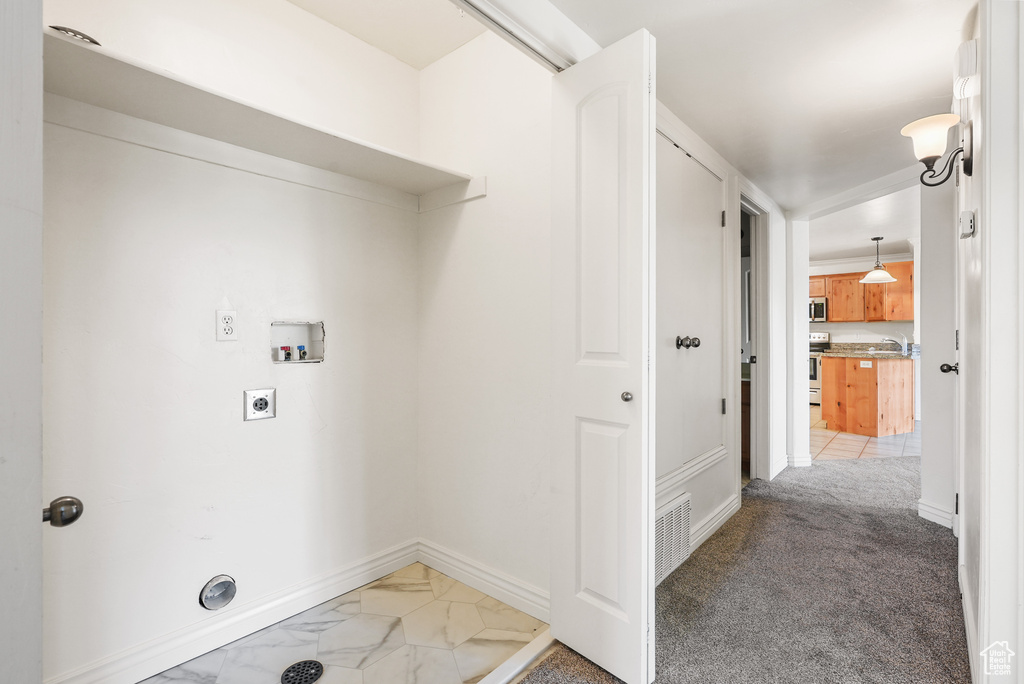 Clothes washing area featuring washer hookup, laundry area, electric dryer hookup, visible vents, and baseboards