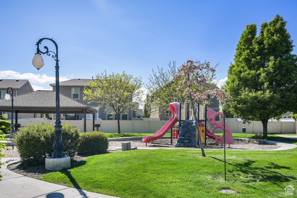 Community playground with a lawn and fence
