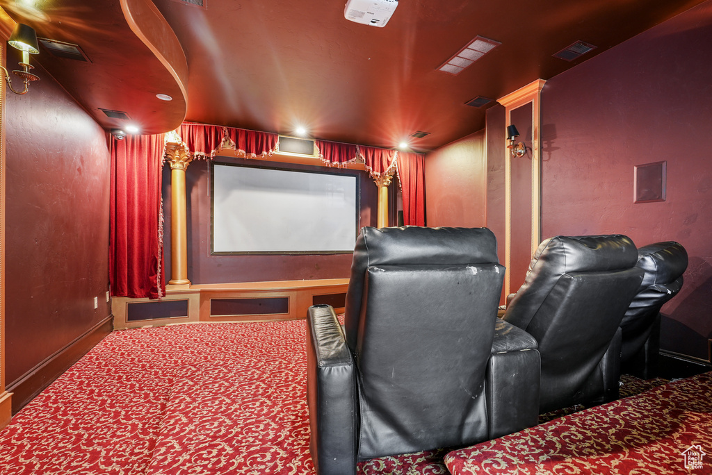 Home theater room with baseboards and visible vents