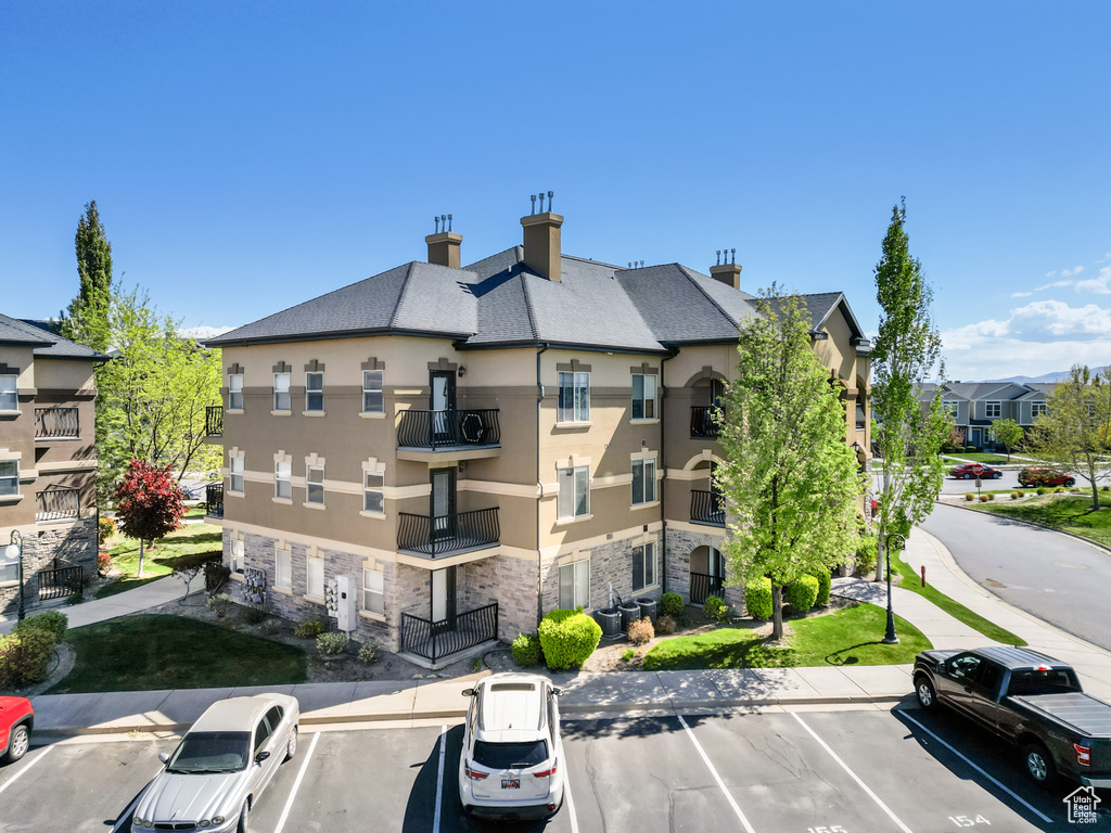 View of property featuring a residential view and uncovered parking